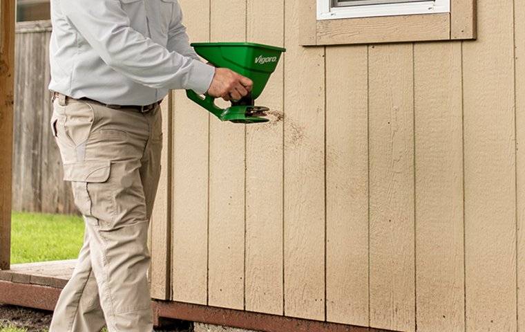 technician putting treatment outside